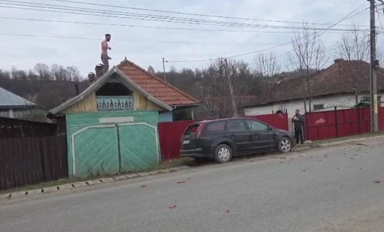 Ca-n filme. Un bărbat s-a urcat pe acoperișul casei și a aruncat cu țiglă în mașina poliției