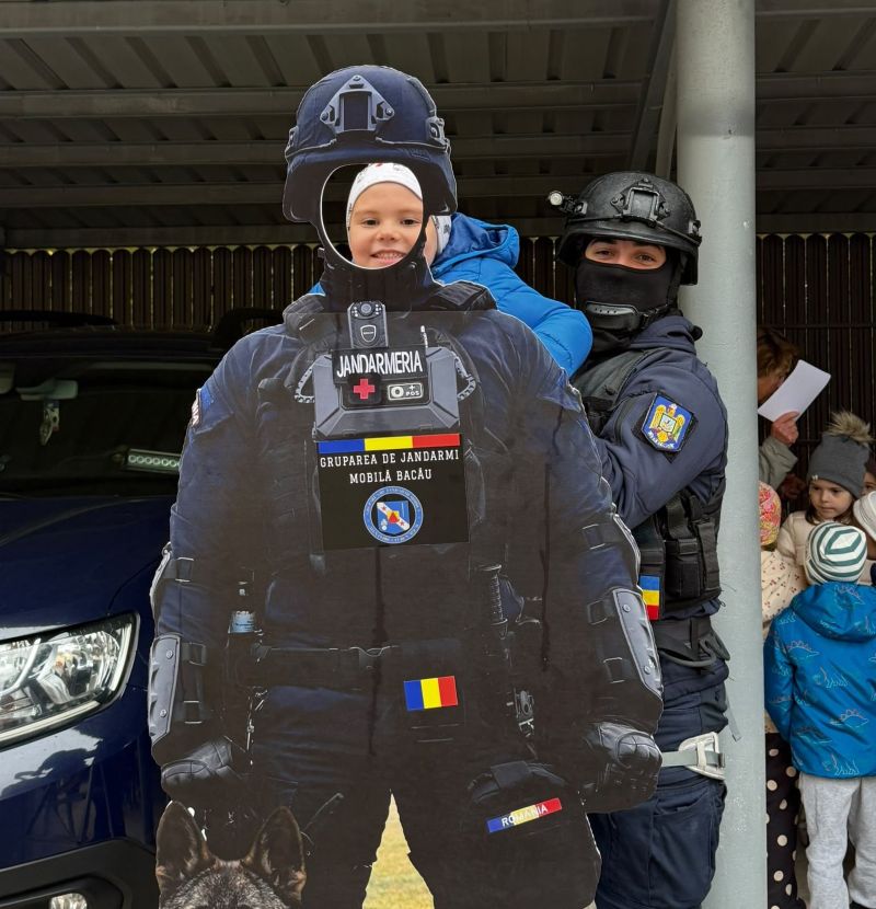 Cop și copil în echipament de jandarmi, zâmbind, la eveniment pentru copii în Bacău.
